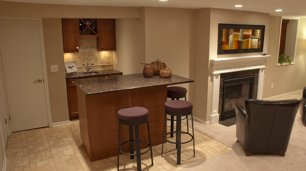 Jacobson Construction New Fireplace Transforms Cold Basement into Warm Family Room